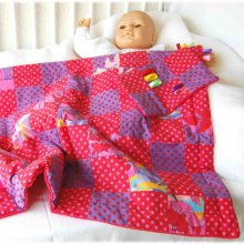 Couverture berceau bébé en coton patchwork et velours à dominante rouge, doublée de ouate